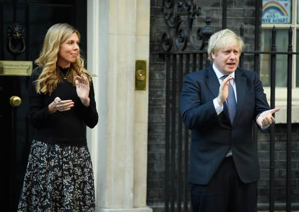 Boris Johnson and his fiancee Carrie Symonds clap for carers outside 10 Downing Street.