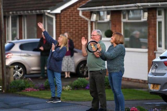 Pictured, residents in Garforth, Leeds #ClapForOurCarers. Photo credit: Jonathan Gawthorpe / jpimediaresell