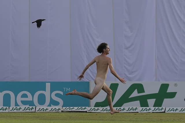 Losing streak: A streaker runs on the field during the second day of the first Test  between Sri Lanka and England in Galle.