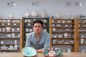 Mike Scrown, Pottery Manager of The Art House, with some of the auction items. Picture: James Hardisty.
