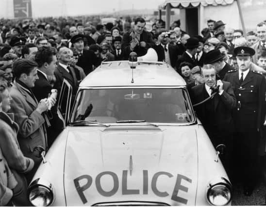2nd November 1959:  Minister of Transport, Ernest Marples uses a police radio telephone to order County Police to open up the newly inaugurated M1 motorway to traffic. The 72 mile section between London and Birmingham is Britain's first motorway.  (Photo by Harry Todd/Fox Photos/Getty Images)