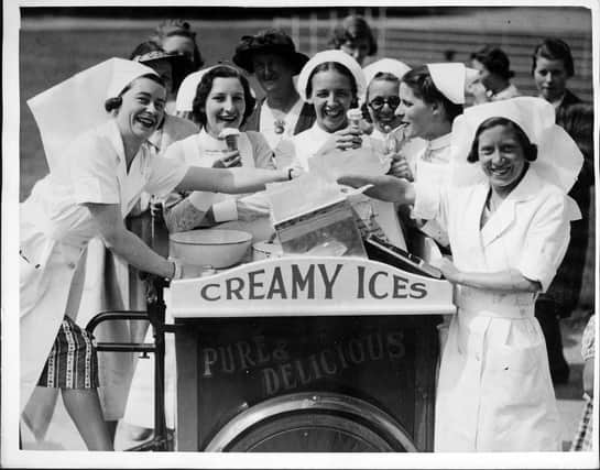 Nurses commandeer the ice-cream man and his 'creamy ices' as soon as he arrives at the Radcliffe Infirmary Fete in Oxford, with his bicycle cart, England.  (Photo by J. R. V. Johnson/Fox Photos/Hulton Archive/Getty Images)