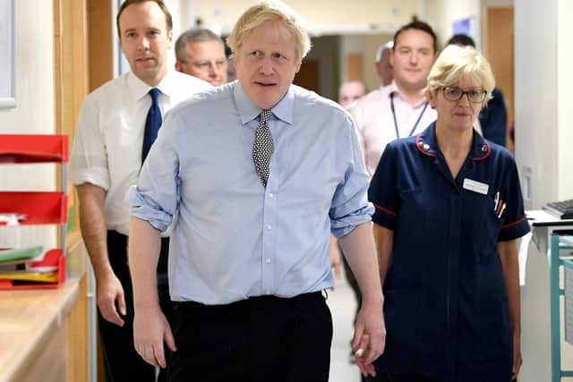 Pictured, Prime Minister Boris Johnson (centre) with Health Secretary Matt Hancock (left) during a visit to Bassetlaw District General Hospital in Worksop, Nottinghamshire, while on the campaign trail for the General Election. Photo credit: Stefan Rousseau/PA