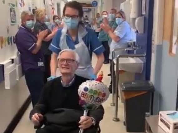 Don Gill, from Beeston, leaving hospital to a round of applause from NHS staff (Photo: Leeds Teaching Hospitals NHS Trust)