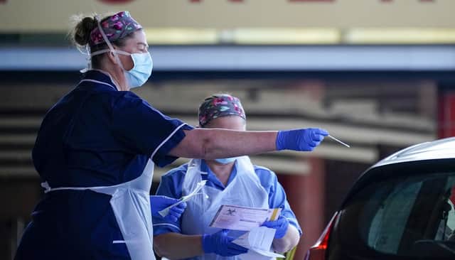 Nurses instruct and help National Health Service (NHS) workers as they self swab for Coronavirus (Covid-19) at a drive through testing site  in Sheffield (Photo by Christopher Furlong/Getty Images)
