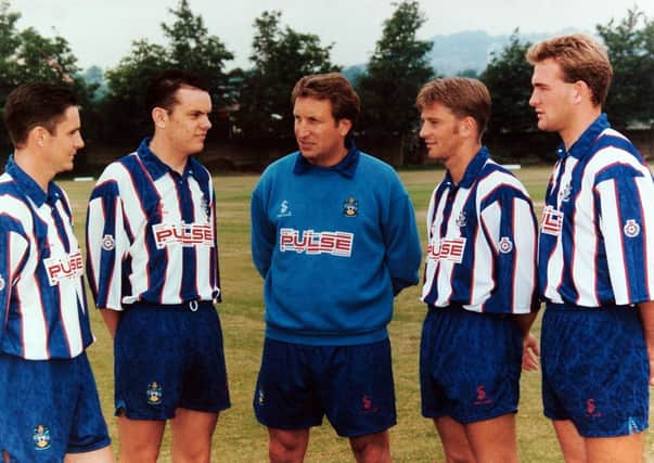 WELCOME: Huddersfield manager Neil Warnock greets his new signings at the Second Division club's photo call in July 1994. From left: Paul Reid, Robbie Ryan, Neil Warnock, Tom Cowan and Kevin Gray.