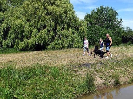 Locals walking on the woodland by a stream that is wanted to be developed for a veterans village in Hull  Pic: Gary Longbottom