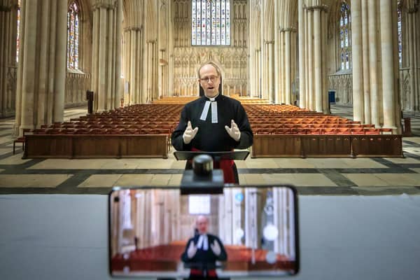 The Revd Michael Smith, York Minster's Canon Pastor, rehearses a digital Evensong service inside the cathedral, as the government moves towards the introduction of measures to bring the country out of lockdown.
