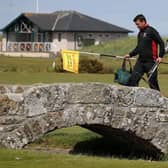 Greenkeeper Simon Connah crosses the Swilcan Bridge on the Old Course at St Andrews, in Fife as final preparations are completed to the course ahead of reopening tomorrow. (Picture: Andrew Milligan/PA Wire)