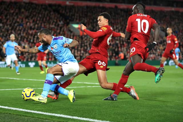 Manchester City's Raheem Sterling (left) goes down under pressure from Liverpool's Trent Alexander-Arnold and Sadio Mane (right) during the Premier League match at Anfield, Liverpool. (Picture: PA)