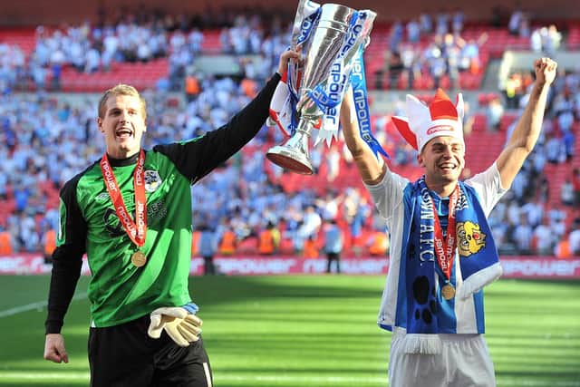 Huddersfield Town's Alex Smithies (left) and Jack Hunt celebrate promotion to the Championship with the Play-Off Trophy after the 2012 final (Picture: PA)