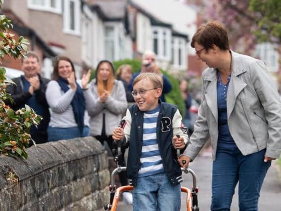 Tobias Weller, who has cerebral palsy and autism, pictured during hiss epic challenge along the street outside his home in Sheffield, South Yorkshire. Photo credit: Joe Giddens / PA