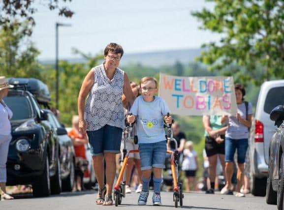 Before he started his fundraising challenge two months ago, nine-year-old Tobias Weller could only manage to walk 50 metres in one go. Photo credit: Joe Giddens/PA