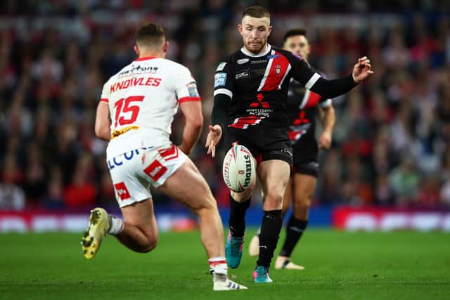 MANCHESTER, ENGLAND - OCTOBER 12: Jackson Hastings of Salford Red Devils kicks the ball under pressure from Morgan Knowles of St Helens during Betfred Super League Grand Final between St Helens and Salford Red Devils at Old Trafford on October 12, 2019 in Manchester, England. (Photo by Clive Brunskill/Getty Images)