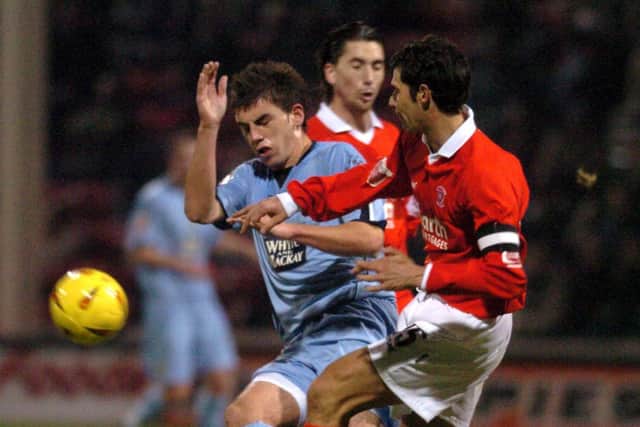 Leeds United's Simon Walton is stopped in his tracks by Rotherham United's Martin McIntosh back in 2004.