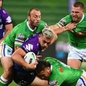 Got him: Elliott Whitehead, right, moves in as Melbourne Storm's Tino Fa'asuamaleaui  is tackled by the Canberra Raiders defence. Picture: Quinn Rooney/Getty Images