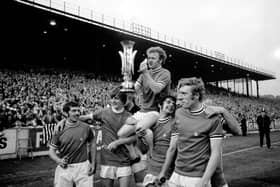Champions: Leeds United captain Billy Bremner holds the Fairs Cup aloft as he celebrates with, from left, Johnny Giles, Allan Clarke, Mick Bates and Mick Jones. Picture: PA