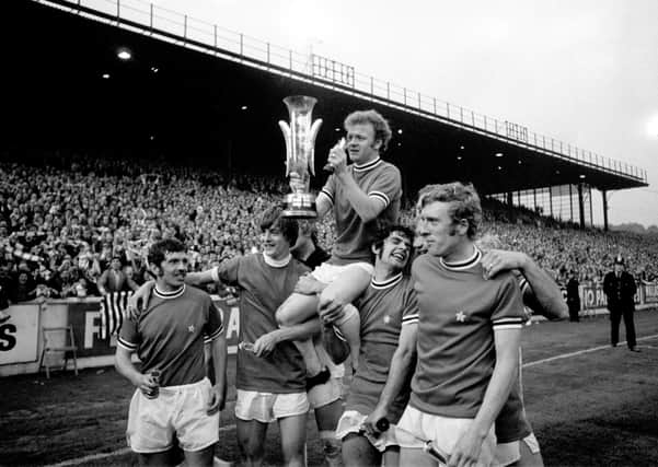 Champions: Leeds United captain Billy Bremner holds the Fairs Cup aloft as he celebrates with, from left, Johnny Giles, Allan Clarke, Mick Bates and Mick Jones. Picture: PA