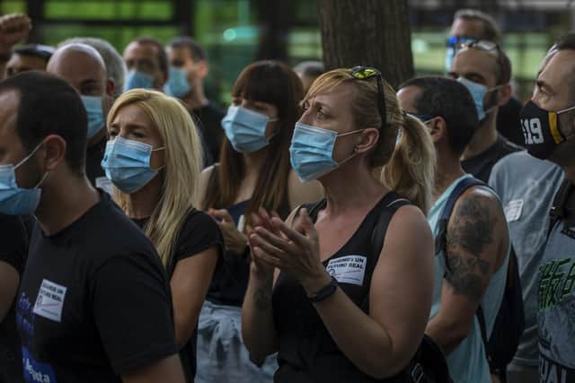 Nissan workers wearing face masks take part in a protest in Barcelona, Spain, Friday, May 29, 2020. Employees in Spain of Japanese giant Nissan took to the streets for the second day in a row to protest the closure of three Barcelona plants as the carmaker scales down its global production. Hundreds of workers have surrounded on Friday at least four of Nissan's car dealerships in or around the northeastern city, covering their windows with leaflets reading "Nissan betrays 25,000 families" and "We will keep fighting" among others.