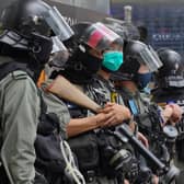 Riot Police stand guard at Central during the second day of debate on a bill that would criminalize insulting or abusing the Chinese anthem in Hong Kong.