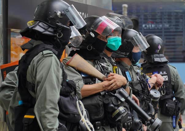 Riot Police stand guard at Central during the second day of debate on a bill that would criminalize insulting or abusing the Chinese anthem in Hong Kong.