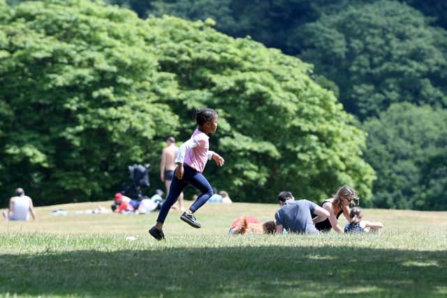Boris Johnson has urged the public not to start gathering indoors as the weather worsens. Pictured: A young girl plays in Roundhay Park over the weekend as lockdown restrictions were lifted.