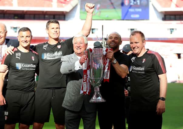 GOING UP: Rotherham United chairman Tony Stewart, seen with manager Paul Warne and his coaching team celebrating the club's last promotion to the second tier two years ago via a Wembley play-off final. Picture: Nigel French/PA