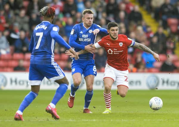 Barnsley's Alex Mowatt comes under pressure from Cardiff's Joe Ralls and Leandro Bacuna