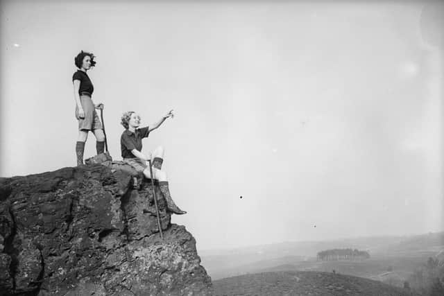 April 1936:  Two female hikers admiring the view near Haslemere, Surrey.  (Photo by Fox Photos/Getty Images)