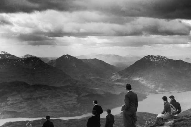 1936:  A group of hikers scale Ben Lomond in Scotland, to gaze down at the Loch below.  (Photo by Fox Photos/Getty Images)