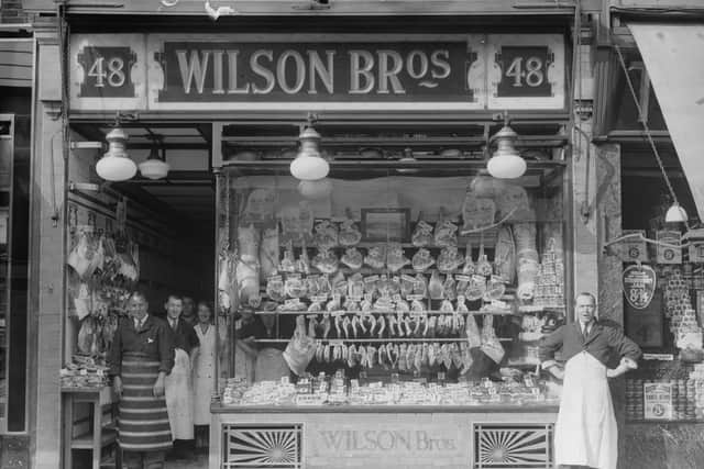 1937:  The staff stand proudly by the window of a  well stocked butcher's shop.  (Photo by General Photographic Agency/Getty Images)