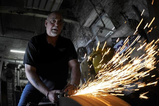 Andy Cole at work on the grinder in his workshop in Portland Works Picture: Simon Hulme