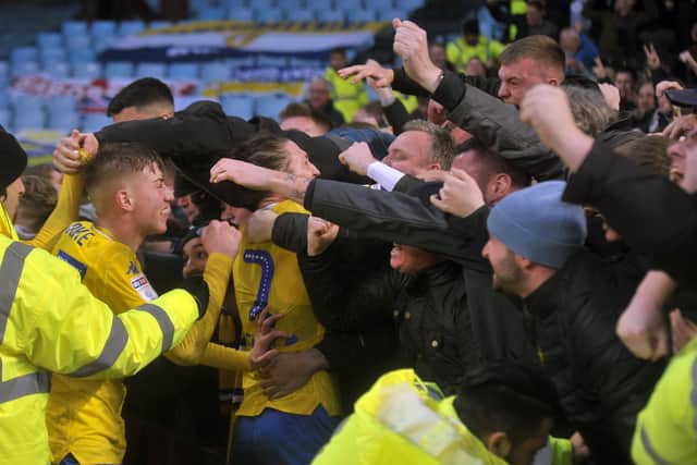 What a win: 
Leeds captain Luke Ayling and Jack Clarke dive into the fans to celebrate Kemar Roofe's winner. Picture: Tony Johnson