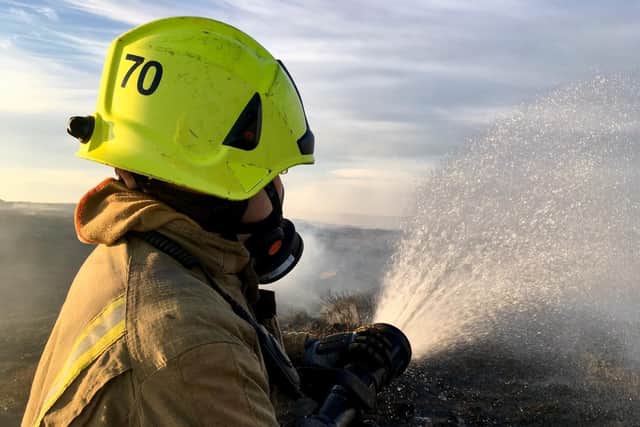 A fire fighter battling a previous moor fire in West Yorkshire. Picture: WYFRS