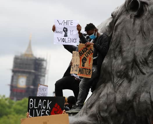Protesters on the statue of a lion during the Black Lives Matter protest rally in Trafalgar Square, London, in memory of George Floyd who was killed on May 25.