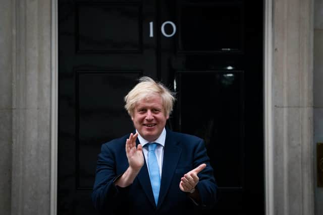 Prime Minister Boris Johnson stands in Downing Street, London, to join in the applause to salute local heroes during Thursday's nationwide Clap for Carers to recognise and support NHS workers and carers fighting the coronavirus pandemic on May 21. Picture: Aaron Chown/PA Wire