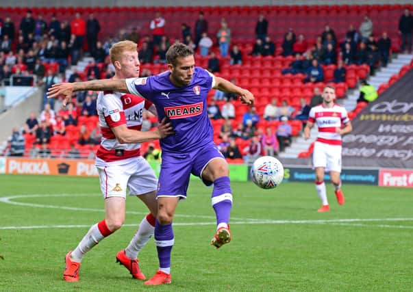 DECISION DAY: Rotherham's Joe Mattock and Doncaster's Brad Halliday battle when the two South Yorkshire rivals met at the Keepmoat Stadium earlier in the season. Picture: Marie Caley