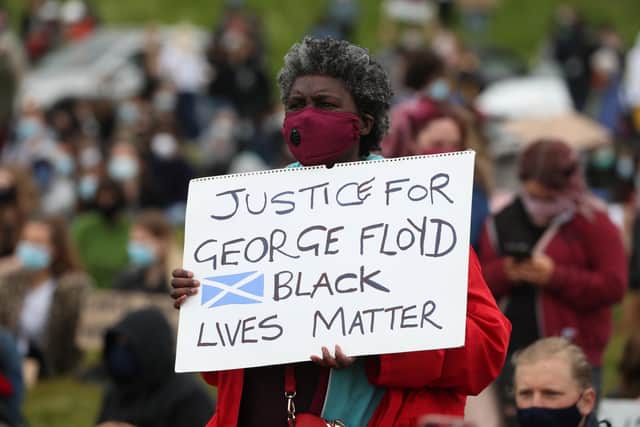 People take part in a Black Lives Matter protest rally in Holyrood Park, Edinburgh, in memory of George Floyd who was killed on May 25 while in police custody in Minneapolis. Picture: Andrew Milligan/PA
