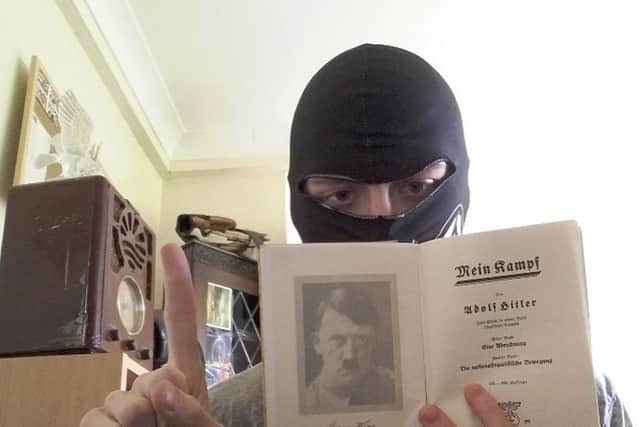 Mark Jones, posing with a copy of Hitler's autobiography, Mein Kampf
