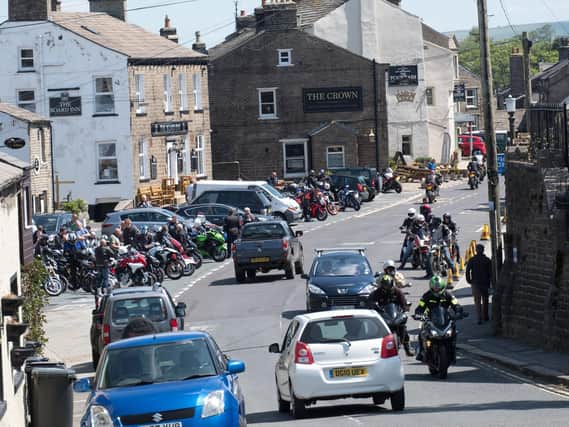 Large groups of bikers gather in Hawes on a warm weekend in May