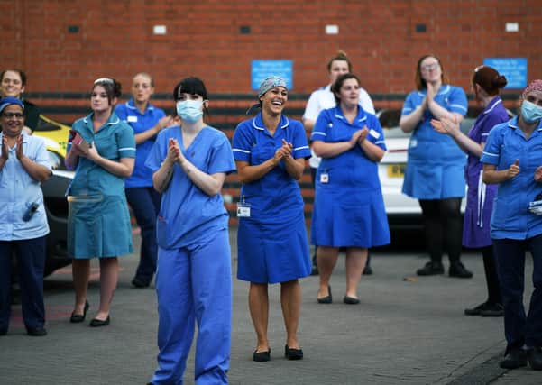 NHS staff in a Clap For Carers celebration outside Leeds General Infirmary.