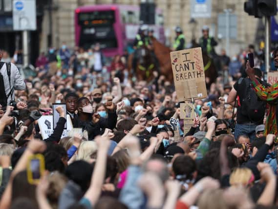 People during a protest calling for the removal of the statue of 19th century imperialist, politician Cecil Rhodes from an Oxford college.