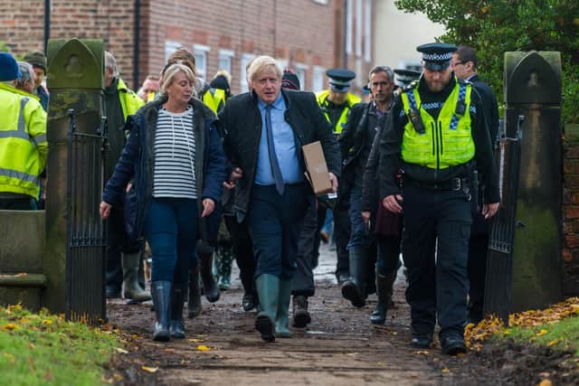 Boris Johnson arrives in Fishlake during the election to meet flooding victims. Photo: James Hardisty.