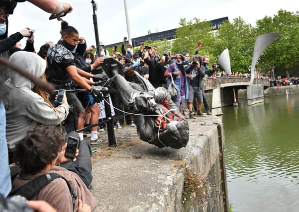 Protesters throw statue of Edward Colston into Bristol harbour during a Black Lives Matter protest rally, in memory of George Floyd who was killed on May 25 while in police custody in the US city of Minneapolis.