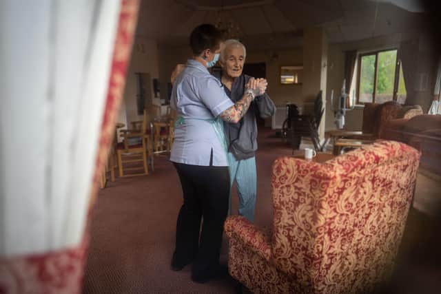 This picture of Jack Dodsley, 79, with a carer in PPE at Newfield Nursing Home, Sheffield, inspired the Duchess of Cambridge to launch a new exhibition. Picture: SWNS