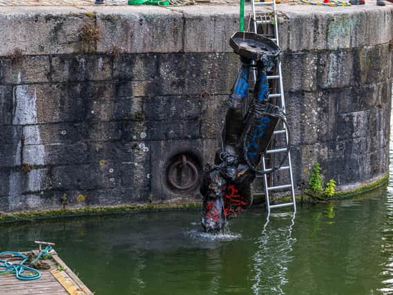 The statue of slave trader Edward Colston is seen being removed from the water in Bristol, where it was dumped by protesters last weekend. (Credit: Rob Browne / SWNS).
