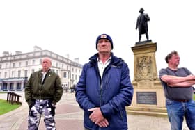 Locals guard the Captain Cook statue in Whitby fearing it may be vandalised by protesters. Picture: Richard Ponter