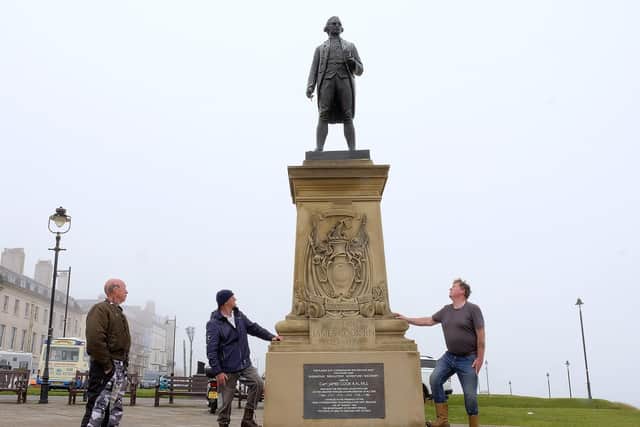 Locals guard the Captain Cook statue in Whitby fearing it may be vandalised by protesters. Picture: Richard Ponter