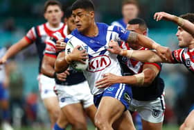 Fa'amanu Brown of Canterbury Bulldogs is tackled against Sydney Roosters in Sydney last June. (Photo by Ryan Pierse/Getty Images)