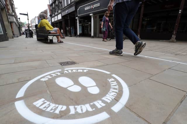 Social distancing signs are now a regular feature on Britain's high streets.